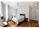 Comfortable bedroom with hardwood floors, neutral walls, a ceiling fan, and a view of the neighborhood at 229 N Church St # 204, Charlotte, NC 28202