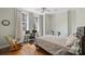 Inviting bedroom featuring hardwood floors, a ceiling fan, a neutral color scheme, and bright, natural light at 229 N Church St # 204, Charlotte, NC 28202