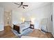 Bright bedroom features hardwood floors, a ceiling fan, natural light, and a comfortable bed setting at 229 N Church St # 204, Charlotte, NC 28202