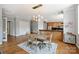 Open-concept dining room adjacent to the modern kitchen, featuring hardwood floors and a contemporary chandelier at 229 N Church St # 204, Charlotte, NC 28202
