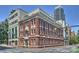 Beautiful multi-story brick building featuring white trim, large windows, and prime corner lot placement near downtown at 229 N Church St # 204, Charlotte, NC 28202
