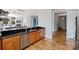 Modern kitchen features stainless steel appliances, wood cabinets, and black granite countertops at 229 N Church St # 204, Charlotte, NC 28202