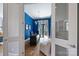 Bright home office features blue walls, hardwood floors, a large desk, and natural light from a window at 229 N Church St # 204, Charlotte, NC 28202
