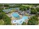 Aerial view of community pools and amenities, with clubhouse, pools, tennis courts, and parking at 238 Horton Grove Rd, Fort Mill, SC 29715