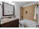 Well-lit bathroom featuring a granite countertop vanity, tub with tile surround and updated fixtures at 238 Horton Grove Rd, Fort Mill, SC 29715