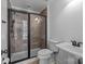 Modern bathroom featuring a glass-enclosed shower with tiled walls and updated fixtures at 238 Horton Grove Rd, Fort Mill, SC 29715