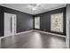 Spacious bedroom with two windows, hardwood flooring, and modern dark gray wall paint at 238 Horton Grove Rd, Fort Mill, SC 29715