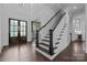Grand foyer with dark wood floors, white staircase and wainscoting at 238 Horton Grove Rd, Fort Mill, SC 29715