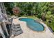 An in-ground pool with a hot tub and elegant stone surround surrounded by mature trees and landscaping at 238 Horton Grove Rd, Fort Mill, SC 29715