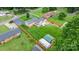An aerial photograph showing a well-kept home with a large lawn, wooden fencing, and outbuildings, ideal for outdoor living at 2401 Hillside Dr, Newton, NC 28658