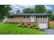 Charming single-story home featuring lush landscaping and a welcoming front entrance at 2401 Hillside Dr, Newton, NC 28658