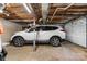Well-lit garage featuring high ceilings and a white car on a concrete floor, providing ample space for parking and storage at 2401 Hillside Dr, Newton, NC 28658
