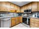 A cozy kitchen with stainless steel appliances, wooden cabinets, and a light countertop at 2401 Hillside Dr, Newton, NC 28658