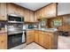 Charming kitchen with wood cabinets, stainless steel appliances, and ceramic tile flooring at 2401 Hillside Dr, Newton, NC 28658