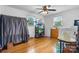 A traditional style laundry room with hardwood floors, a ceiling fan, and a deep freezer at 2401 Hillside Dr, Newton, NC 28658