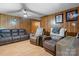 Comfortable living room with wood paneling, plush seating, and a ceiling fan at 2401 Hillside Dr, Newton, NC 28658