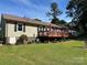 Backyard with deck, manicured bushes, large windows and well-maintained lawn at 2401 Hoffman St, Gastonia, NC 28054