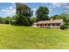 Single-story home with a spacious front yard, mature trees, and a two-car garage providing ample parking at 2401 Hoffman St, Gastonia, NC 28054