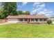 Charming single-story home with a well-manicured lawn, a red front door and a two-car garage at 2401 Hoffman St, Gastonia, NC 28054