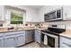 Modern kitchen featuring stainless steel appliances, sleek countertops, and a window providing natural light at 2401 Hoffman St, Gastonia, NC 28054