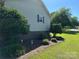 Landscaped yard with manicured shrubs and brick foundation at 2401 Hoffman St, Gastonia, NC 28054