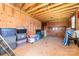 The outbuilding's interior has wooden walls and floors, cabinets, and ample storage, offering potential for customization at 2401 Hoffman St, Gastonia, NC 28054