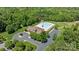 Overhead view of community pool, clubhouse, and parking nestled amidst lush greenery at 2414 Madeira Cir, Waxhaw, NC 28173