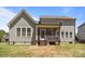 The backyard features a screened in porch and stairs to the manicured yard at 2414 Madeira Cir, Waxhaw, NC 28173