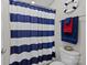 Nautical themed bathroom with blue and white striped shower curtain and decorative life preserver at 2414 Madeira Cir, Waxhaw, NC 28173