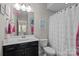 Bathroom featuring vanity, framed mirror, and tub with shower curtain at 2414 Madeira Cir, Waxhaw, NC 28173