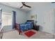 Bedroom with ceiling fan, area rug, carpet flooring, and a window with dark curtains at 2414 Madeira Cir, Waxhaw, NC 28173