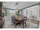 Dining room with an arched entryway, chandelier, large table, and view into an adjacent room at 2414 Madeira Cir, Waxhaw, NC 28173
