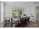 Bright dining room featuring a large table, chairs, and access to a screened-in porch at 2414 Madeira Cir, Waxhaw, NC 28173