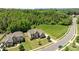 Two-story home featuring stone and siding, a manicured lawn, and lush landscaping at 2414 Madeira Cir, Waxhaw, NC 28173