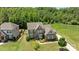 Two-story home featuring stone and siding, a manicured lawn, and lush landscaping at 2414 Madeira Cir, Waxhaw, NC 28173