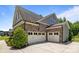 Three car garage with neutral doors at a charming two-story stone home at 2414 Madeira Cir, Waxhaw, NC 28173