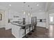 Bright kitchen with a large island, bar stools, and modern stainless steel appliances at 2414 Madeira Cir, Waxhaw, NC 28173