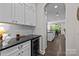 Kitchen with a wine fridge, white cabinets, and a view into the kitchen and living areas at 2414 Madeira Cir, Waxhaw, NC 28173