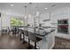 Modern kitchen featuring a large island with bar seating, stainless steel appliances, and granite countertops at 2414 Madeira Cir, Waxhaw, NC 28173