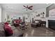 Open concept living room with a fireplace, comfortable seating, and a view into the kitchen at 2414 Madeira Cir, Waxhaw, NC 28173