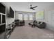 Spacious carpeted living room providing ample space, a ceiling fan, and great natural light at 2414 Madeira Cir, Waxhaw, NC 28173