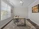 Bright office space with a large window, modern desk, and coffered ceiling at 2414 Madeira Cir, Waxhaw, NC 28173