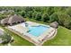 Community pool with lounge chairs and a splash pad surrounded by greenery and trees at 2414 Madeira Cir, Waxhaw, NC 28173
