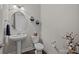 Contemporary powder room with pedestal sink, round mirror and modern decor at 2414 Madeira Cir, Waxhaw, NC 28173