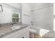 Bathroom with a granite countertop, shower, and large, bright window at 304 Adams St, Salisbury, NC 28144