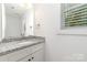 Bathroom featuring granite countertop and a large, bright mirror at 304 Adams St, Salisbury, NC 28144