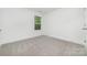 Neutral-toned bedroom with plush carpet, white walls, and bright window at 304 Adams St, Salisbury, NC 28144