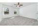 Spacious bedroom with plush carpeting, ceiling fan and two bright windows at 304 Adams St, Salisbury, NC 28144