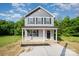 Two-story home featuring gray siding, black shutters and a covered front porch at 304 Adams St, Salisbury, NC 28144