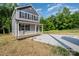 Two-story home with gray siding, black shutters, and a charming covered porch at 304 Adams St, Salisbury, NC 28144